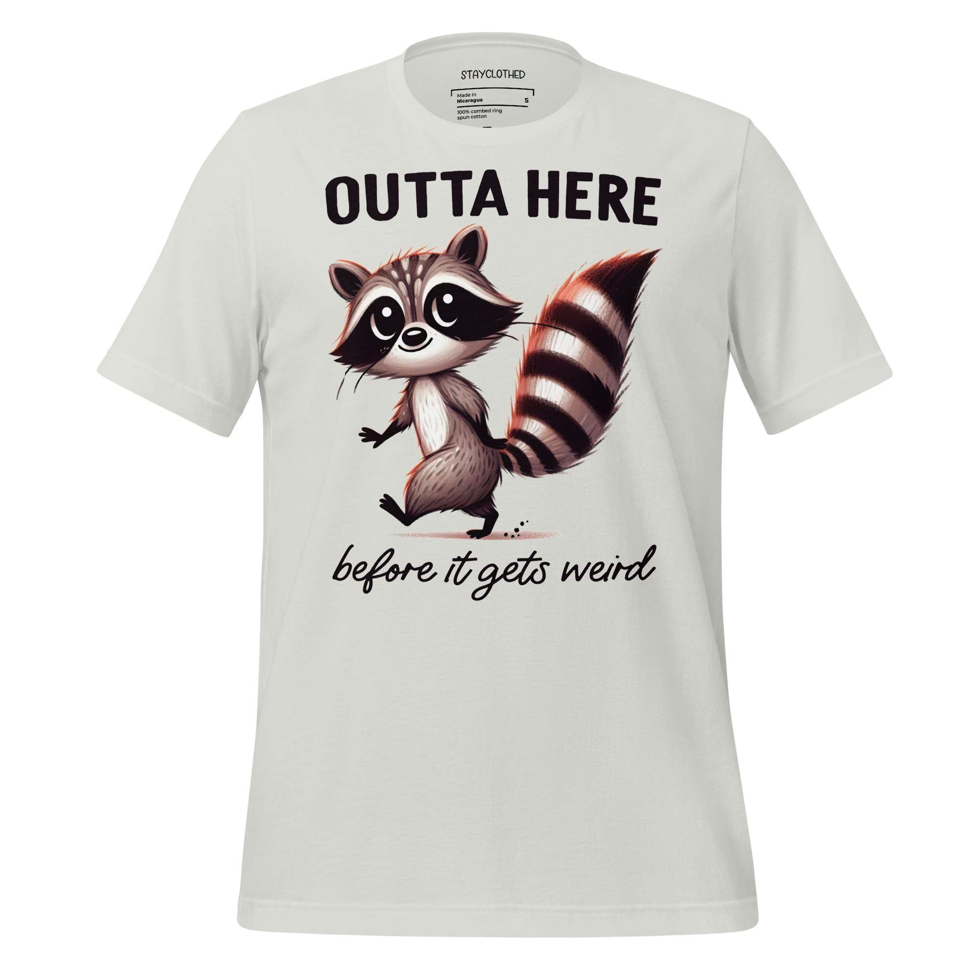 White t-shirt with a raccoon graphic and text on a wooden surface, featuring the brand 'StayClothed'.