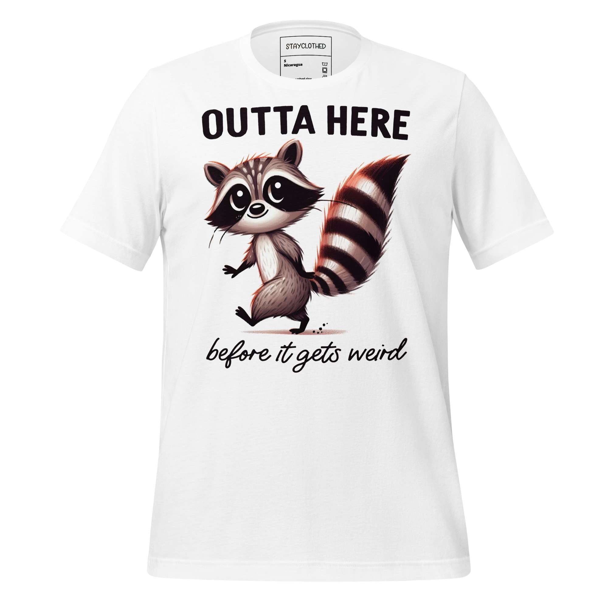 White t-shirt with a raccoon graphic and text on a wooden surface, featuring the brand 'StayClothed'.
