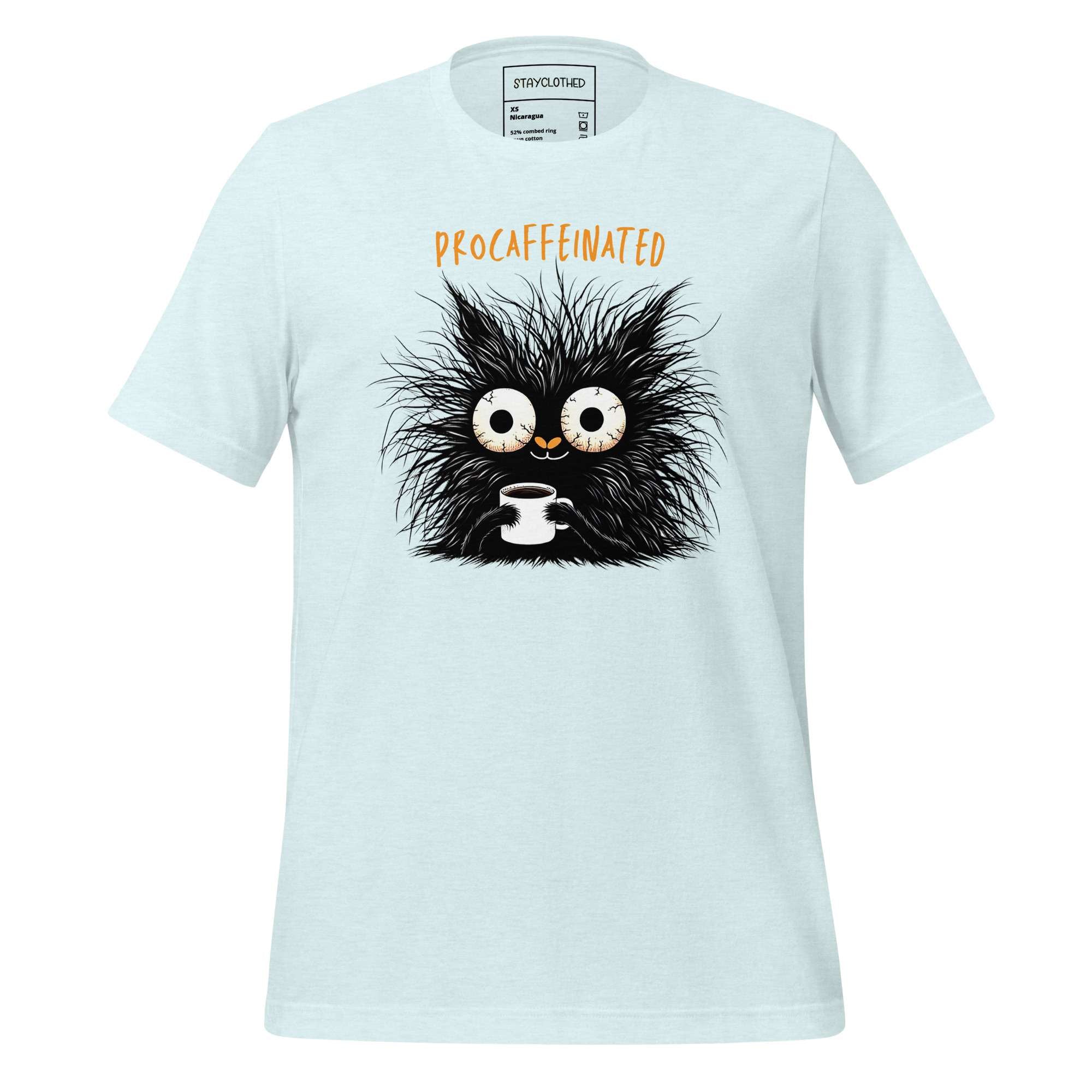 White t-shirt with a black creature holding a coffee cup on a wooden surface, featuring the brand 'StayClothed'.
