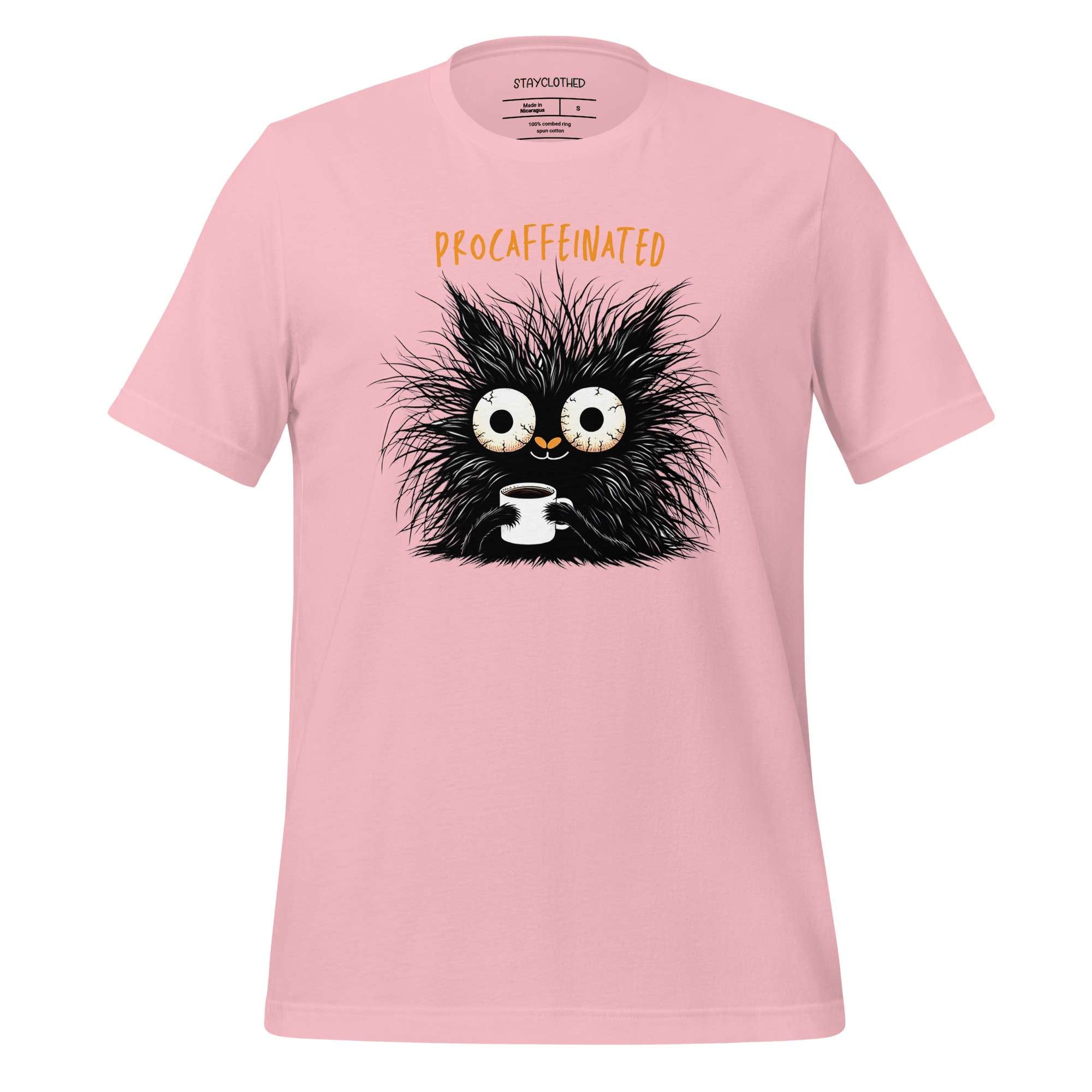 Pink t-shirt with a black cat graphic and 'Decaf' text on a wooden surface, featuring the brand 'StayClothed'.