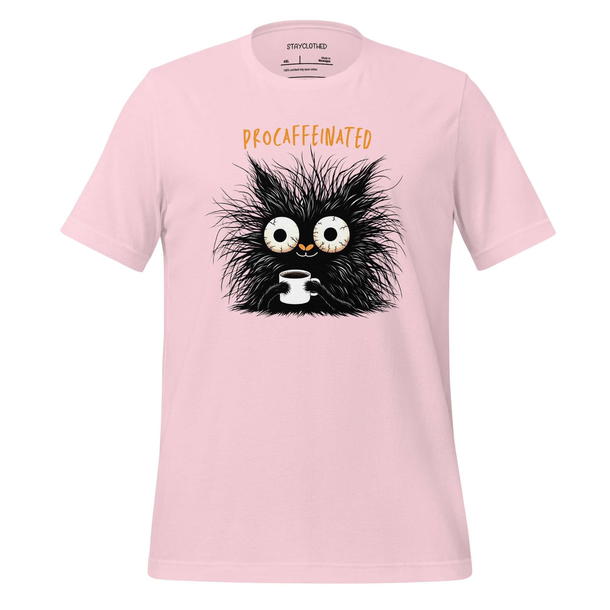 Pink t-shirt with a cartoon cat design on a wooden surface, featuring the brand 'StayClothed'.