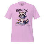 Pink t-shirt with a raccoon graphic and text on a wooden surface, featuring the brand 'StayClothed'.
