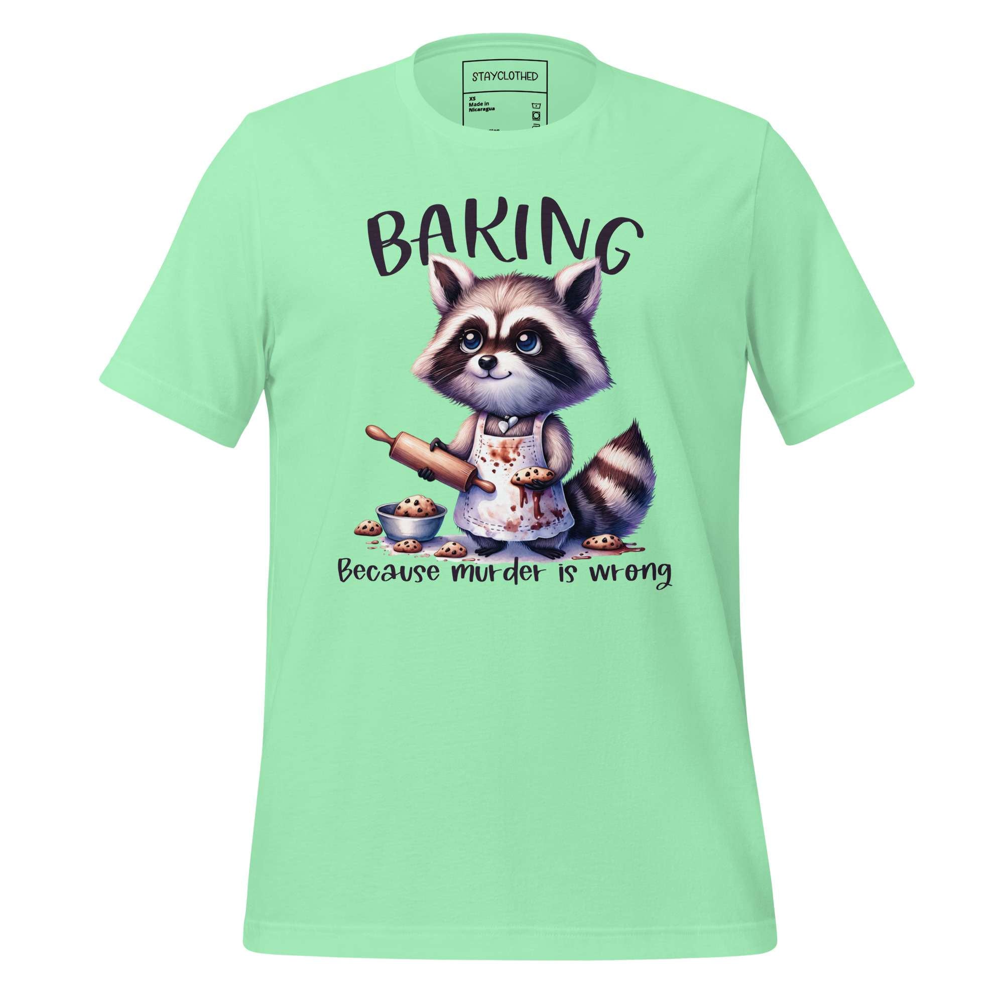Light green t-shirt with a raccoon graphic and text on a wooden surface, featuring the brand 'StayClothed'.