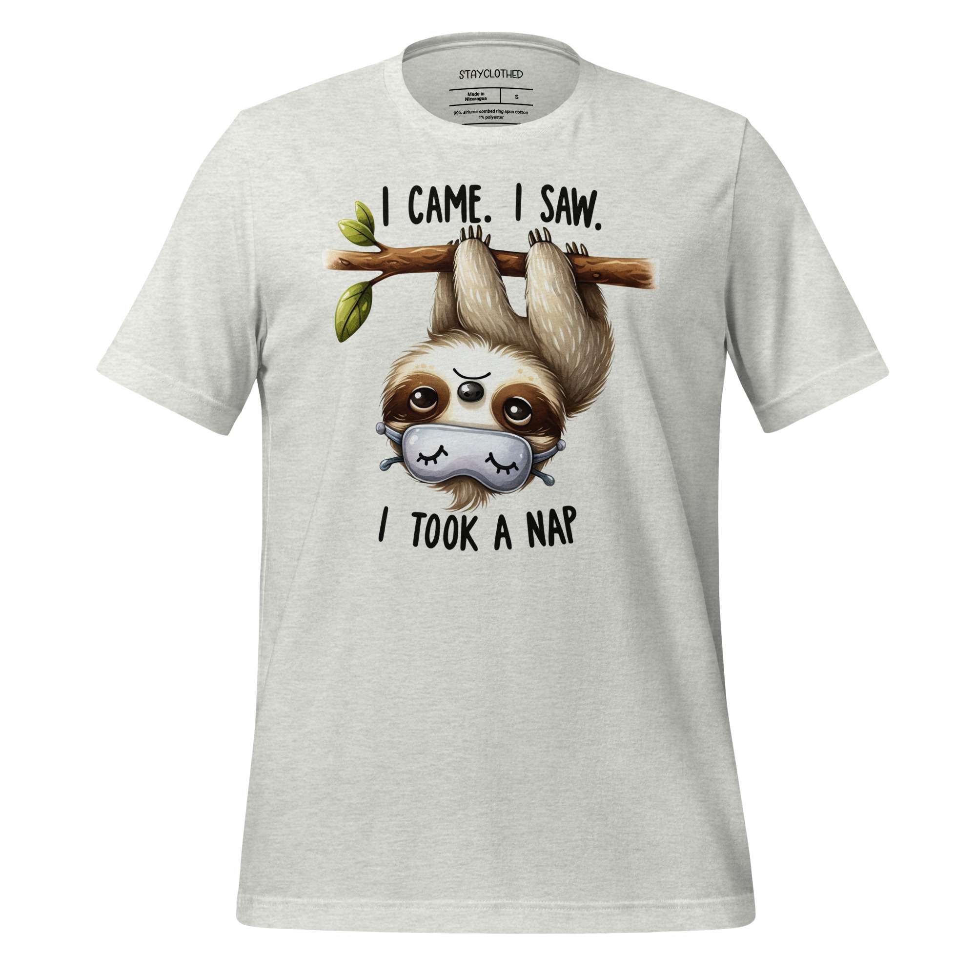 White t-shirt with a sloth graphic and text on a wooden surface, featuring the brand 'StayClothed'.