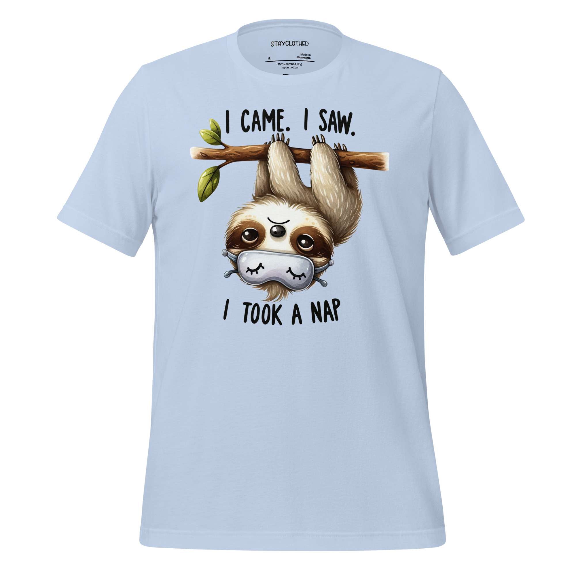 White t-shirt with a sloth graphic and text on a wooden surface, featuring the brand 'StayClothed'.