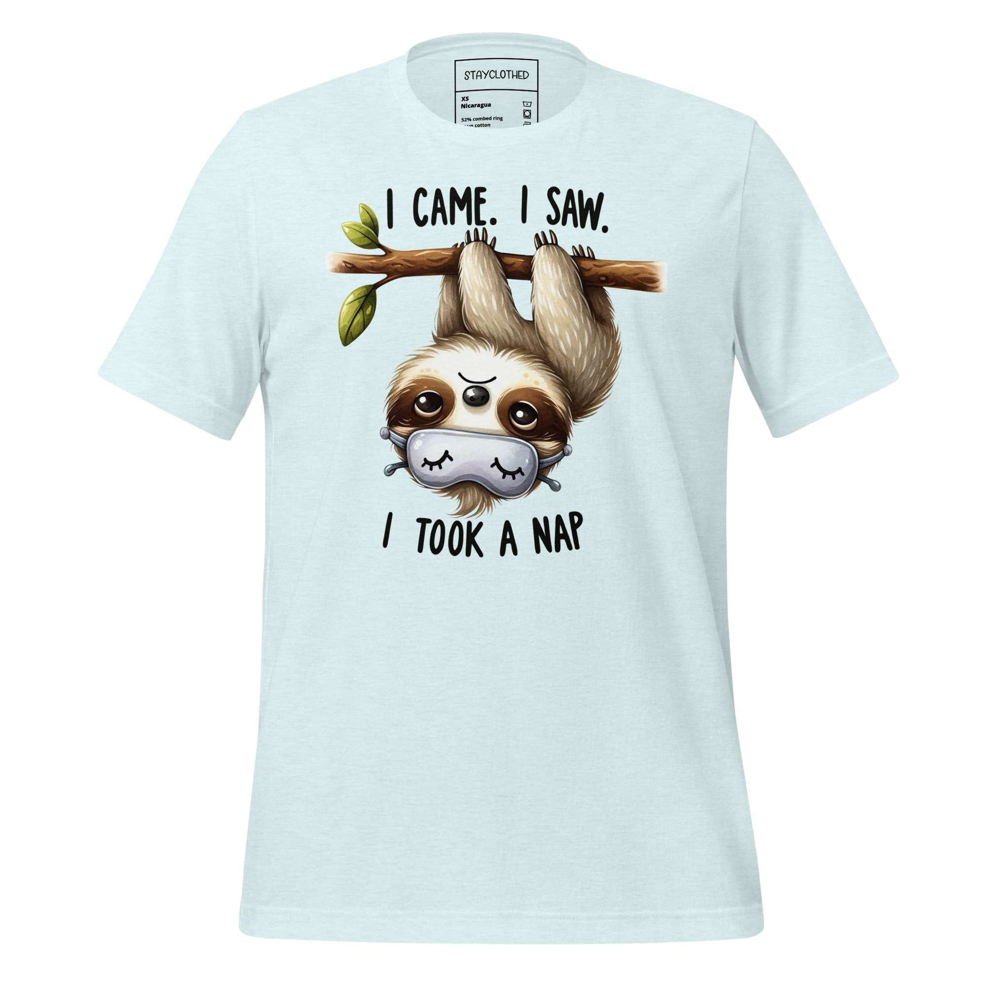 White t-shirt with a sloth graphic and text on a wooden surface, featuring the brand 'StayClothed'.