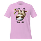 Pink t-shirt with a sloth graphic and text on a wooden surface, featuring the brand 'StayClothed'.