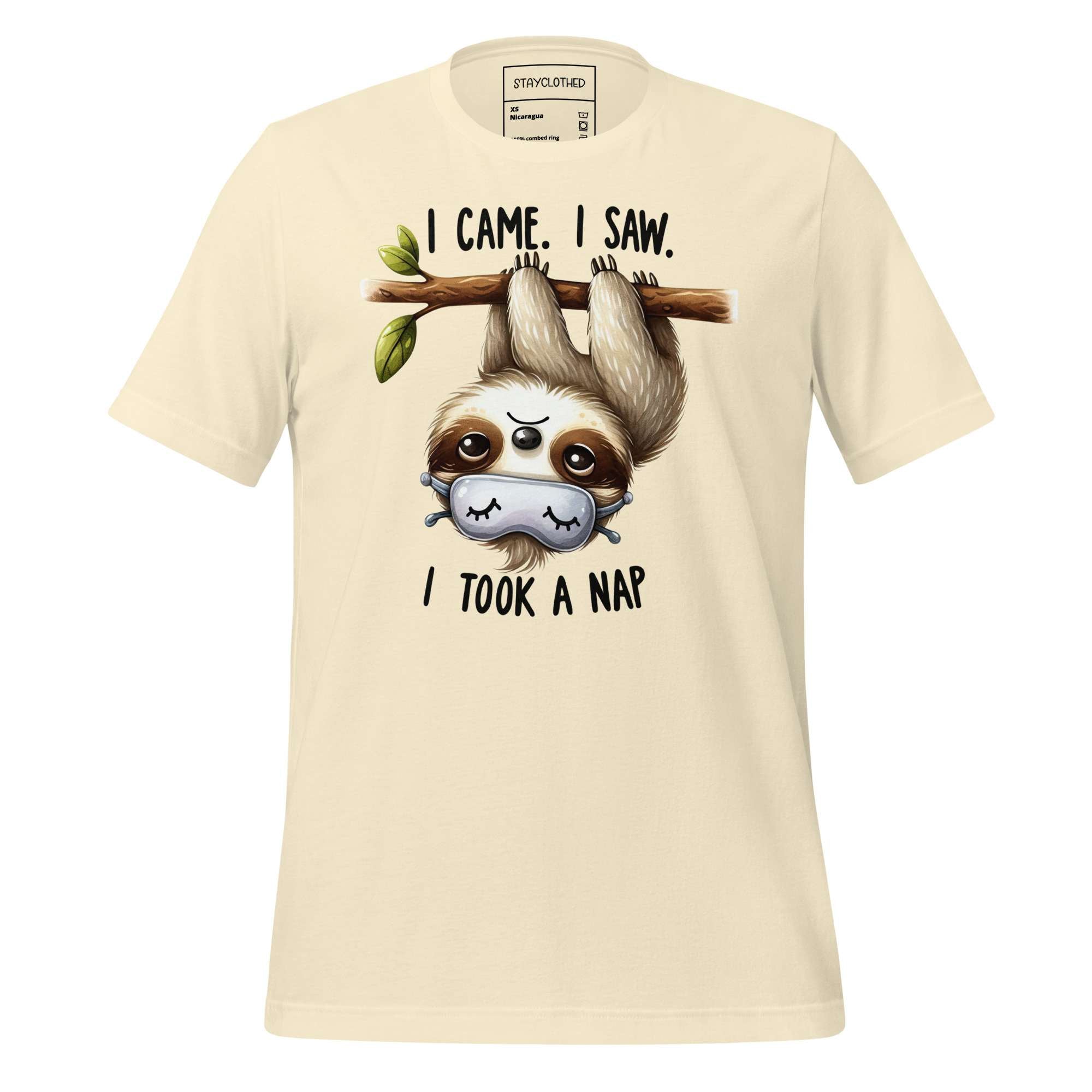 Beige t-shirt with a sloth graphic and text on a wooden surface, featuring the brand 'StayClothed'.