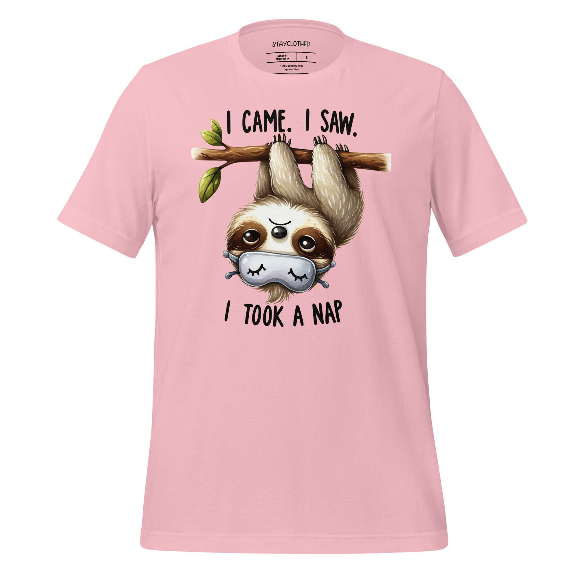 Pink t-shirt with a sloth graphic and text on a wooden surface, featuring the brand 'StayClothed'.