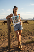 Model wearing the Loves America Western Racerback Tank Top in a country field scene