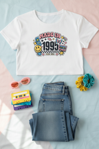 Made in 1995 Icon Era Crop Top flat lay styled with a denim skirt and retro accessories