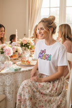 Model wearing the Mama Pastel Bow Crop Top in a soft motherhood lifestyle scene