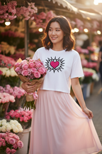 Model wearing the Pink Heart Burst Crop Top with a pink skirt in a flower garden scene