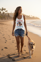 Model wearing the Proudly Pawtriotic Racerback Tank Top while walking a dog on a beach at sunset