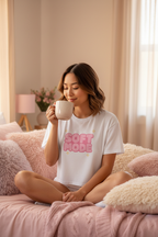 Model wearing the Soft Mode Pink Bubble Crop Top while sitting on a cosy bed