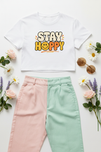 Stay Happy Women’s Crop Top flat lay styled with pastel trousers and soft accessories
