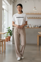Model wearing the Unbothered Minimalist Crop Top in a neutral home interior scene