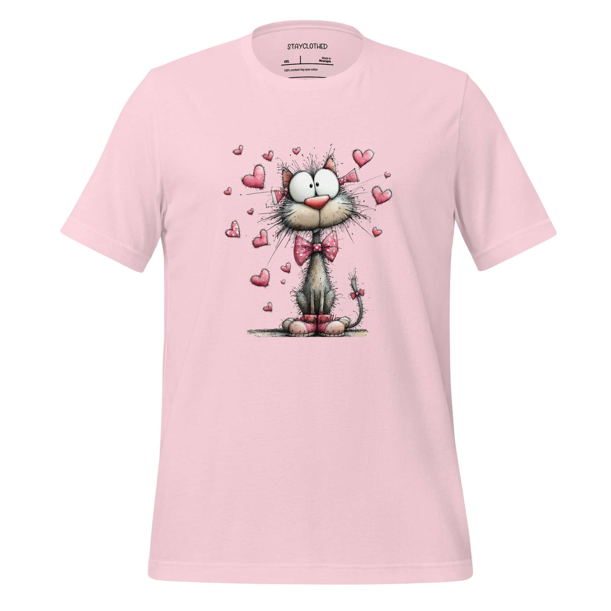 Pink t-shirt with a cat graphic and hearts on a wooden surface, featuring the brand 'StayClothed'.