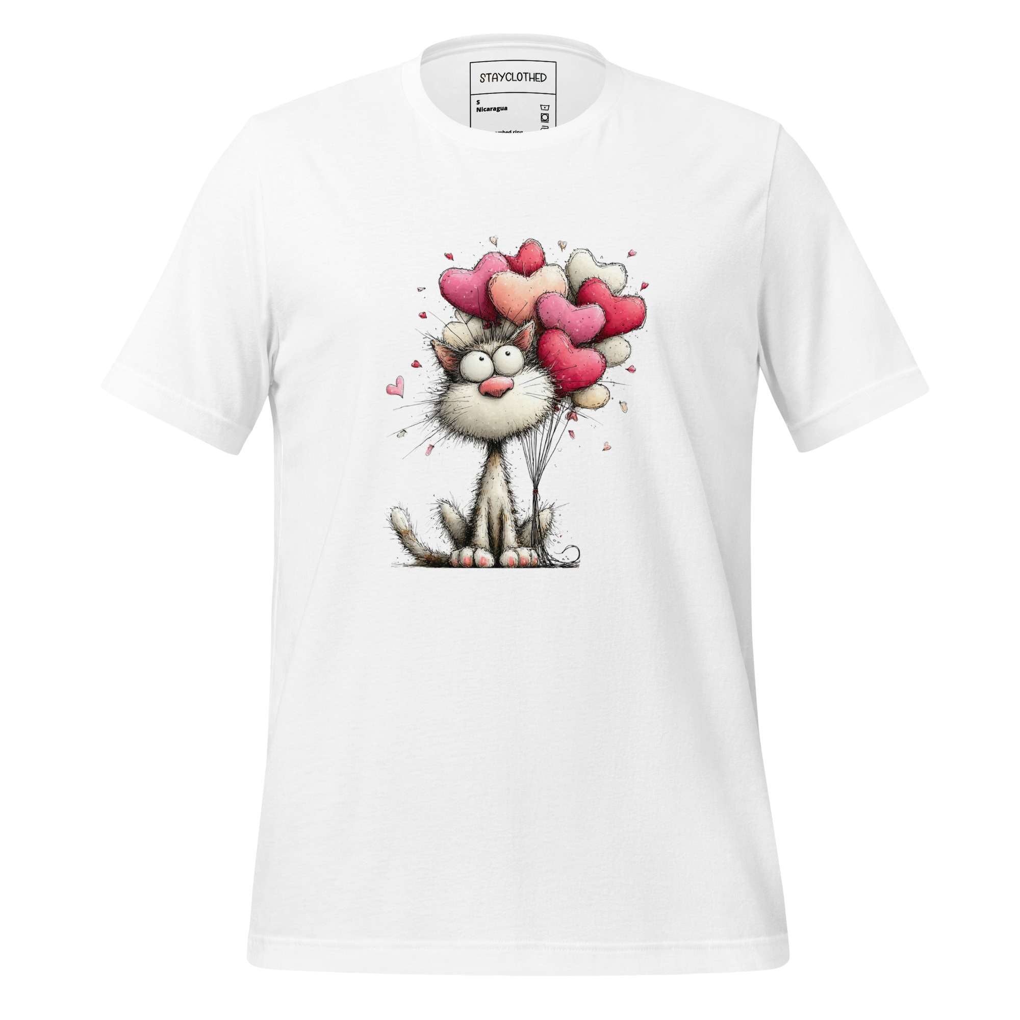 White t-shirt with a cat holding heart balloons design on a wooden surface, featuring the brand 'StayClothed'.