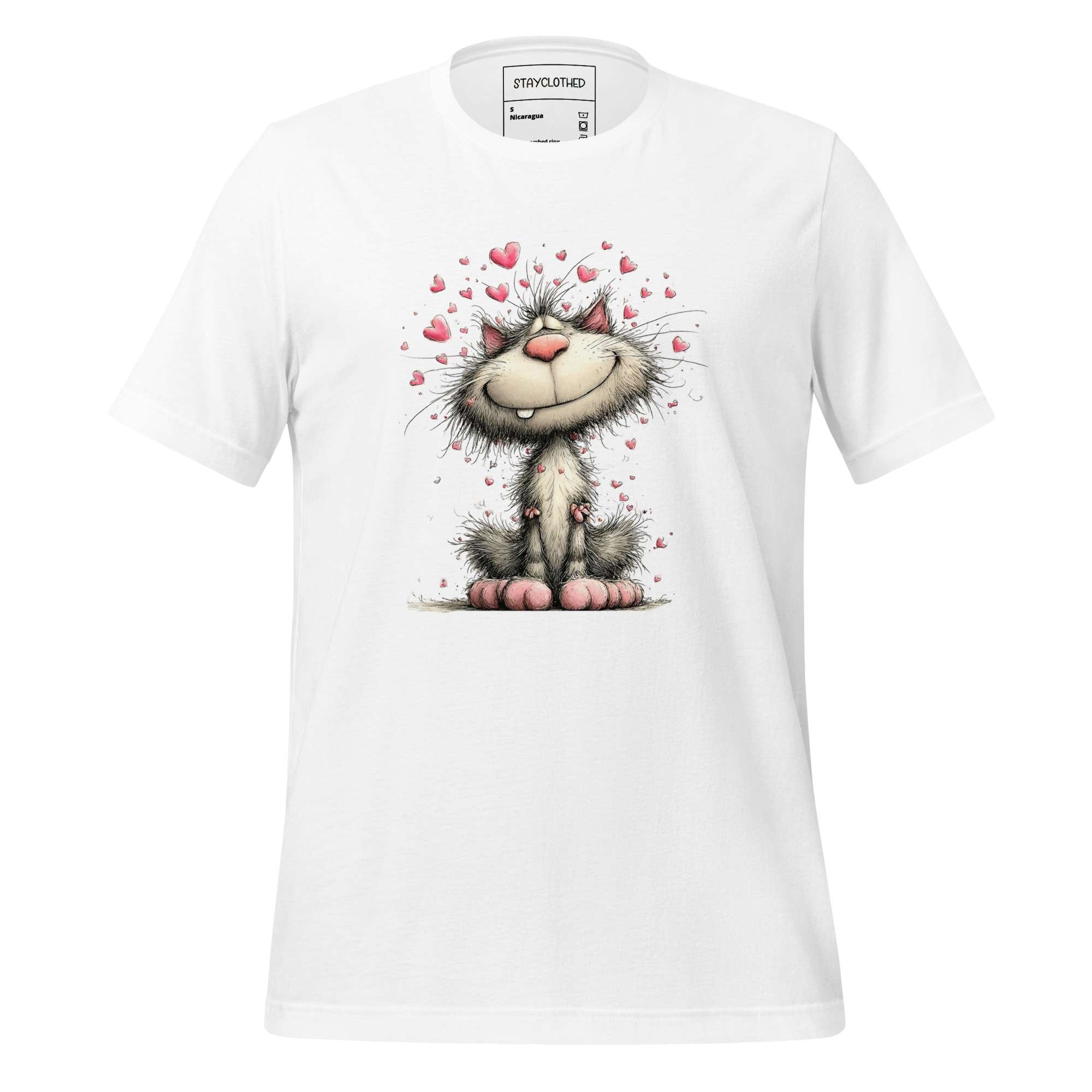 White t-shirt with a cartoon cat design on a wooden surface, featuring the brand 'StayClothed'.