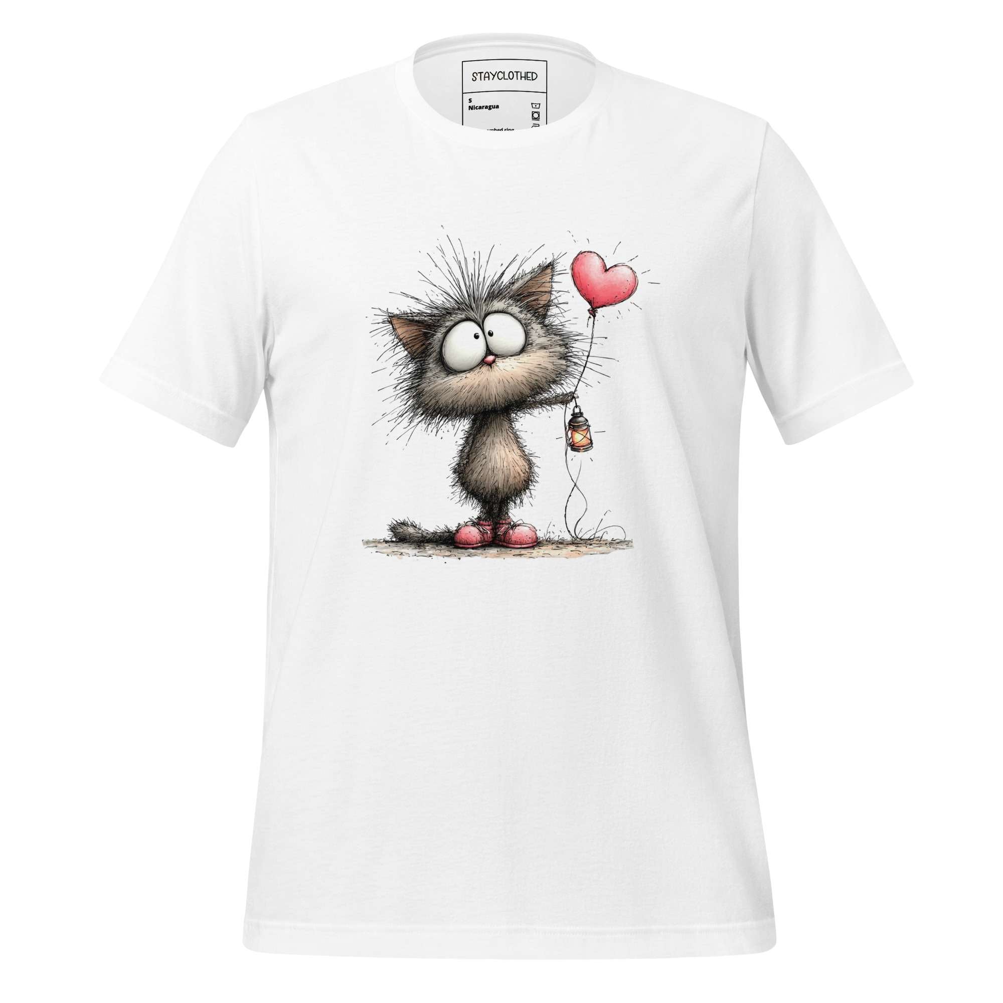 White t-shirt with cartoon cat design on a wooden surface, featuring the brand 'StayClothed'.