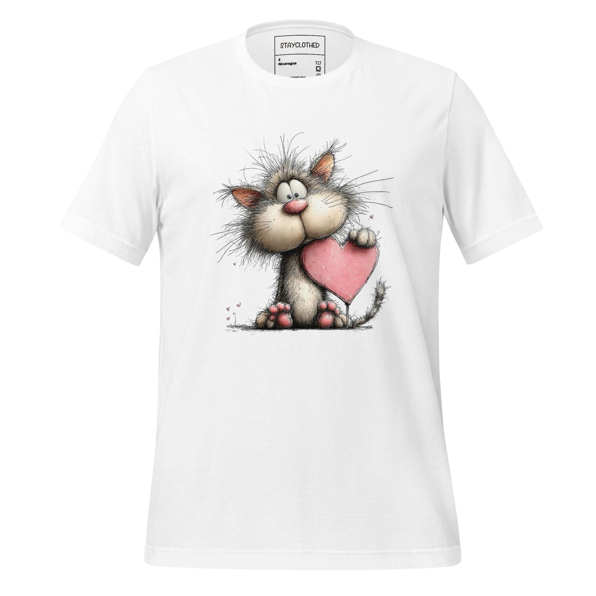 White t-shirt with a cartoon cat holding a heart on a wooden surface, featuring the brand 'StayClothed'.