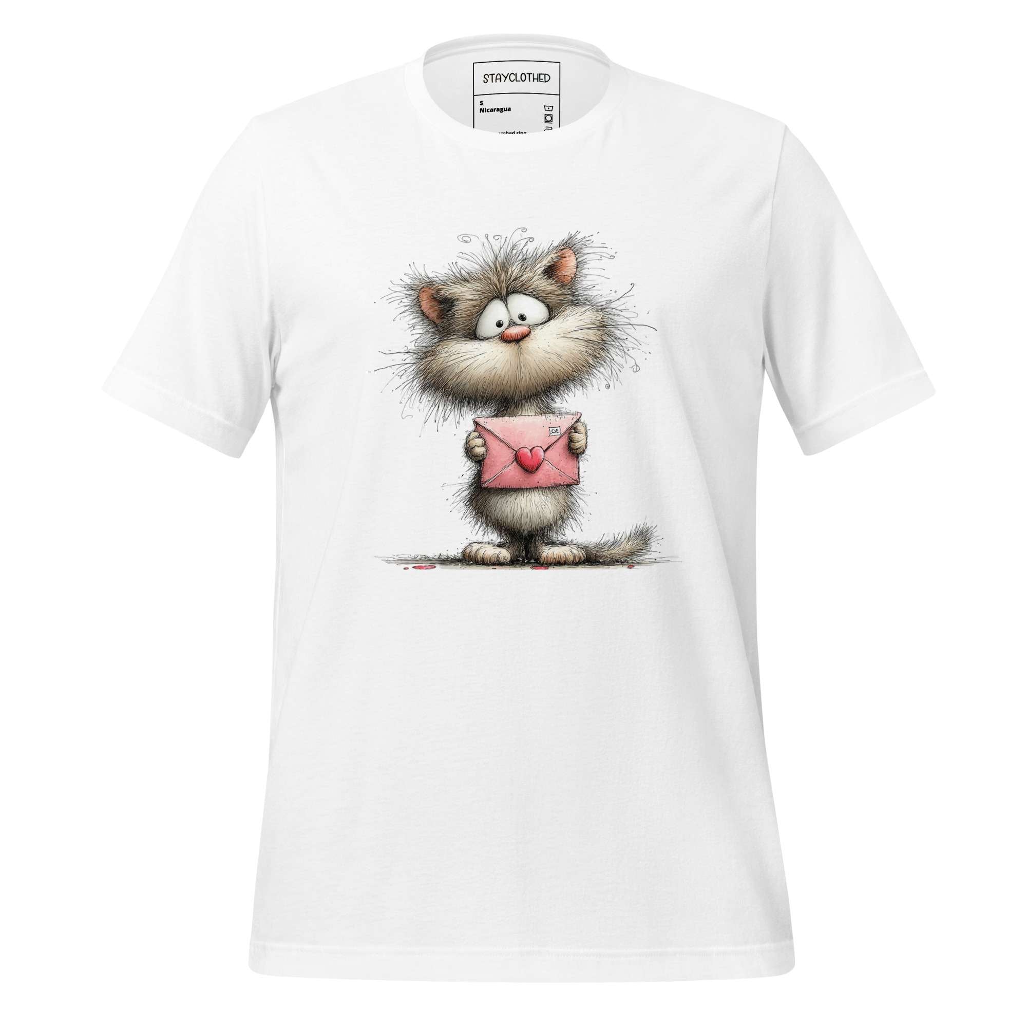 White t-shirt with a cartoon cat holding a pink envelope on a wooden surface, featuring the brand 'StayClothed'.