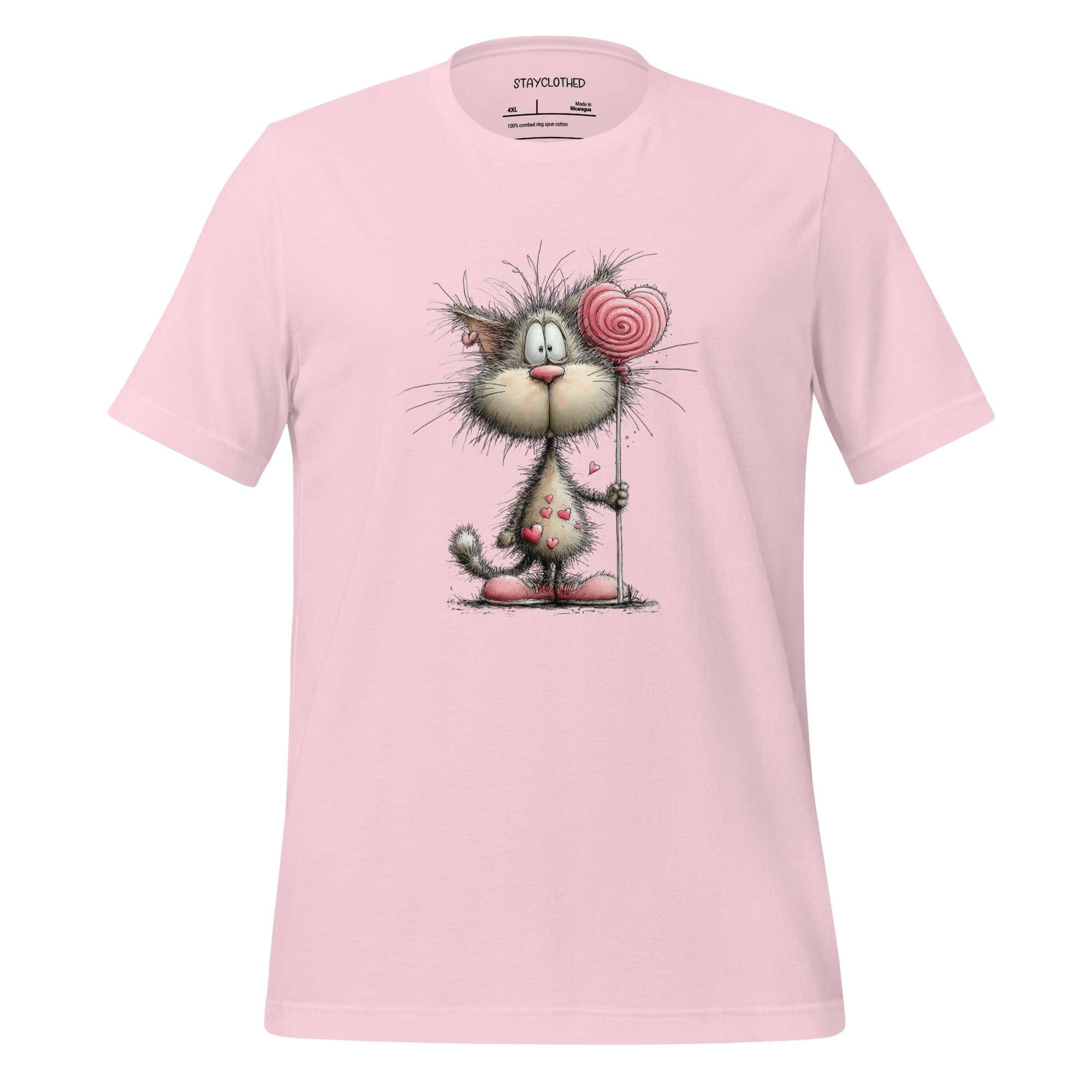 Pink t-shirt with a cartoon cat design on a wooden surface, featuring the brand 'StayClothed'.