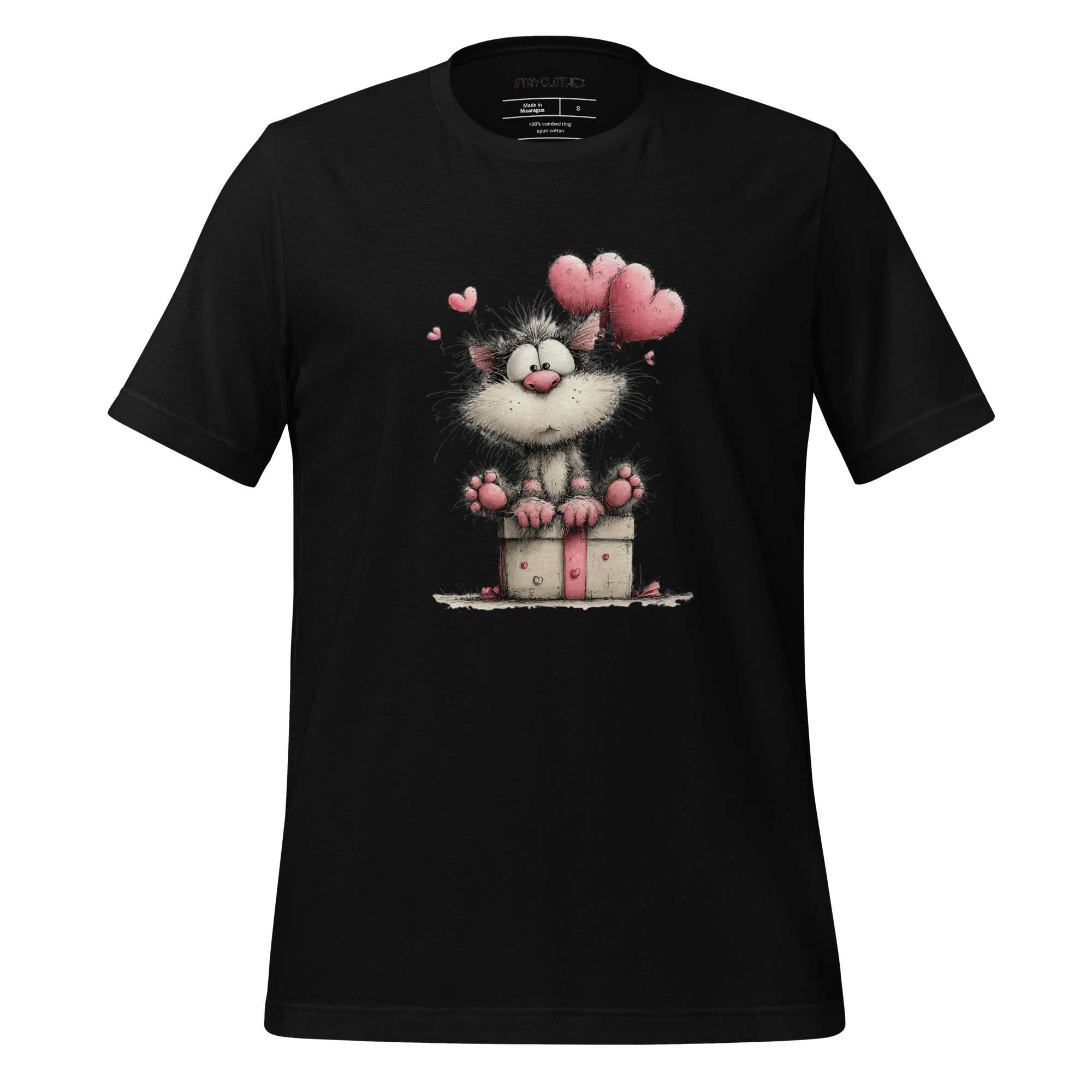 Black t-shirt with a cartoon cat design on a wooden surface, featuring the brand 'StayClothed'.