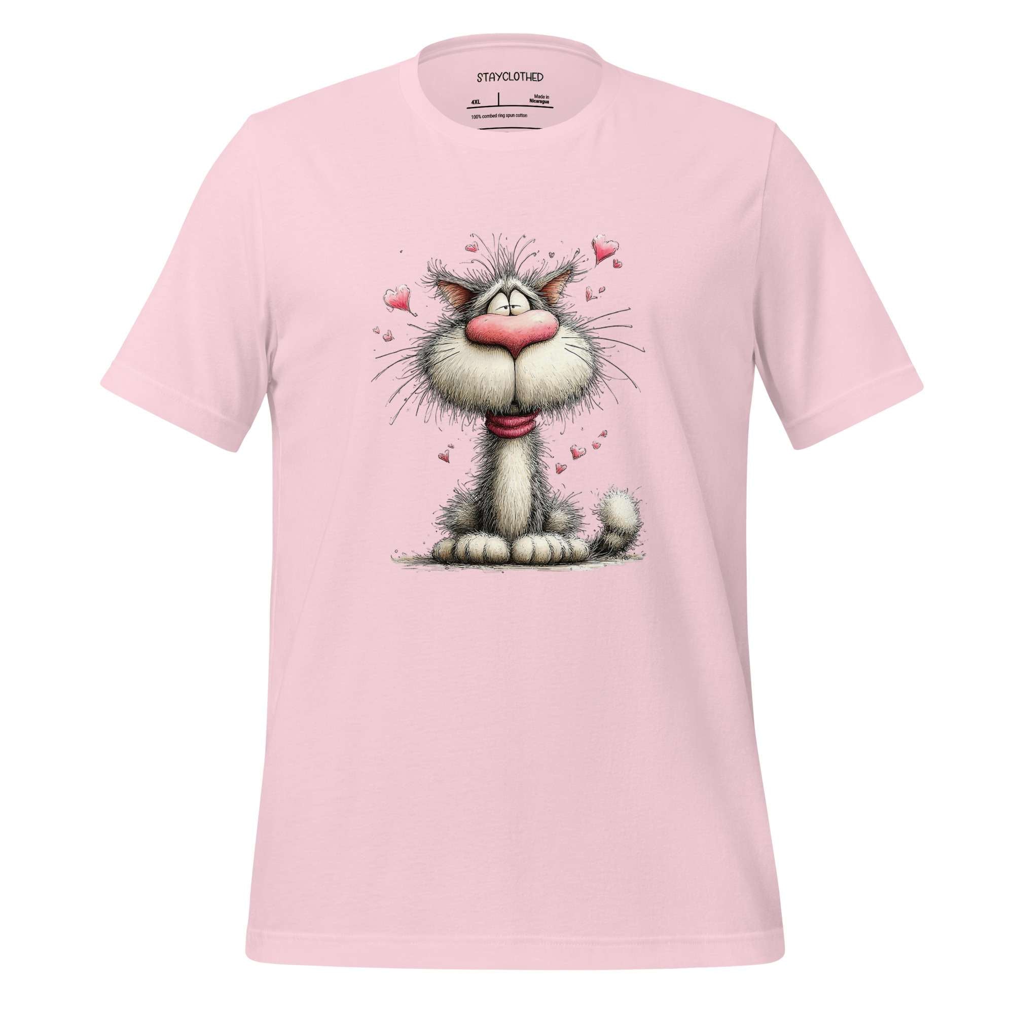Pink t-shirt with a cartoon cat design on a wooden surface, featuring the brand 'StayClothed'.