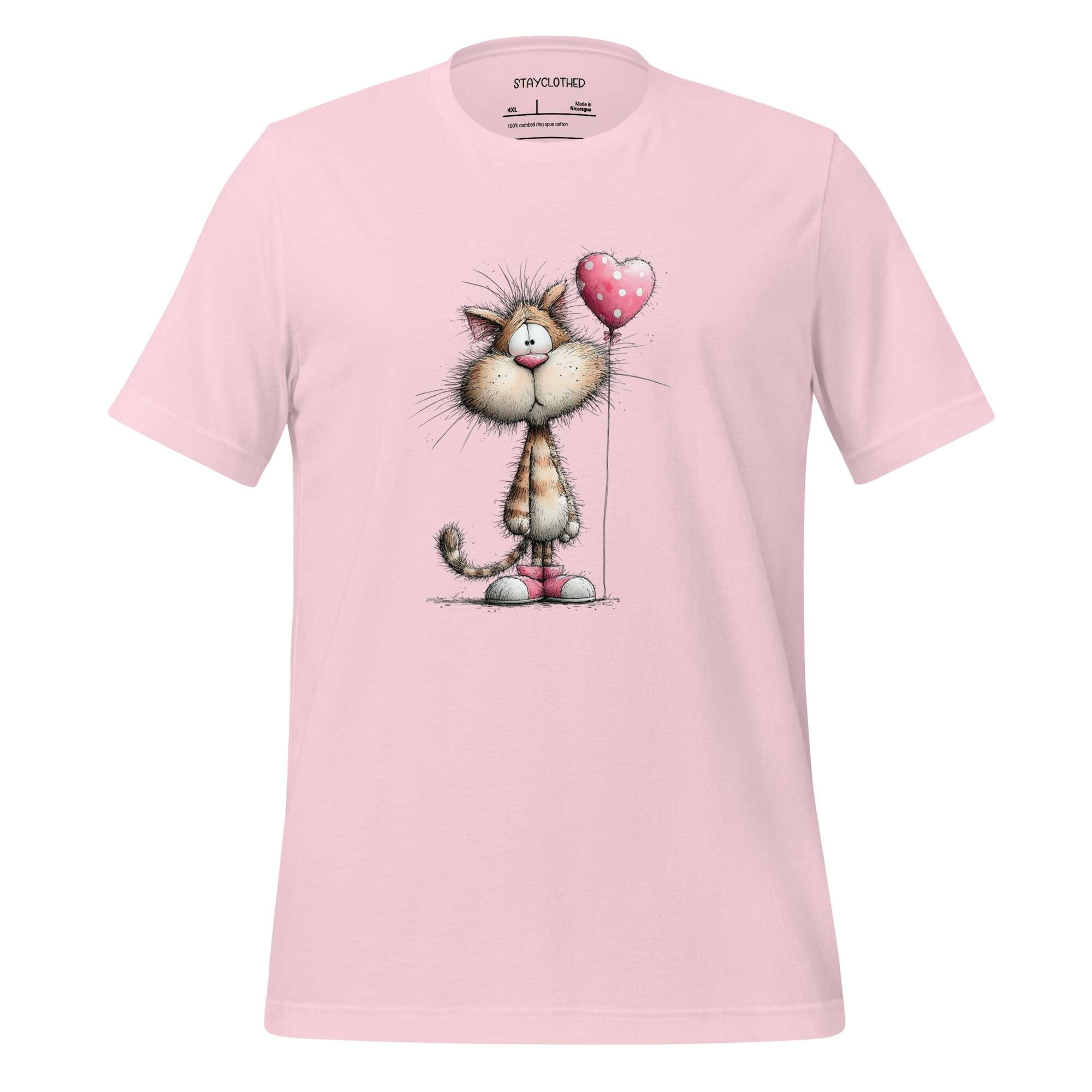 Pink t-shirt with cartoon cat holding a heart on a wooden surface, featuring 'StayClothed' brand.