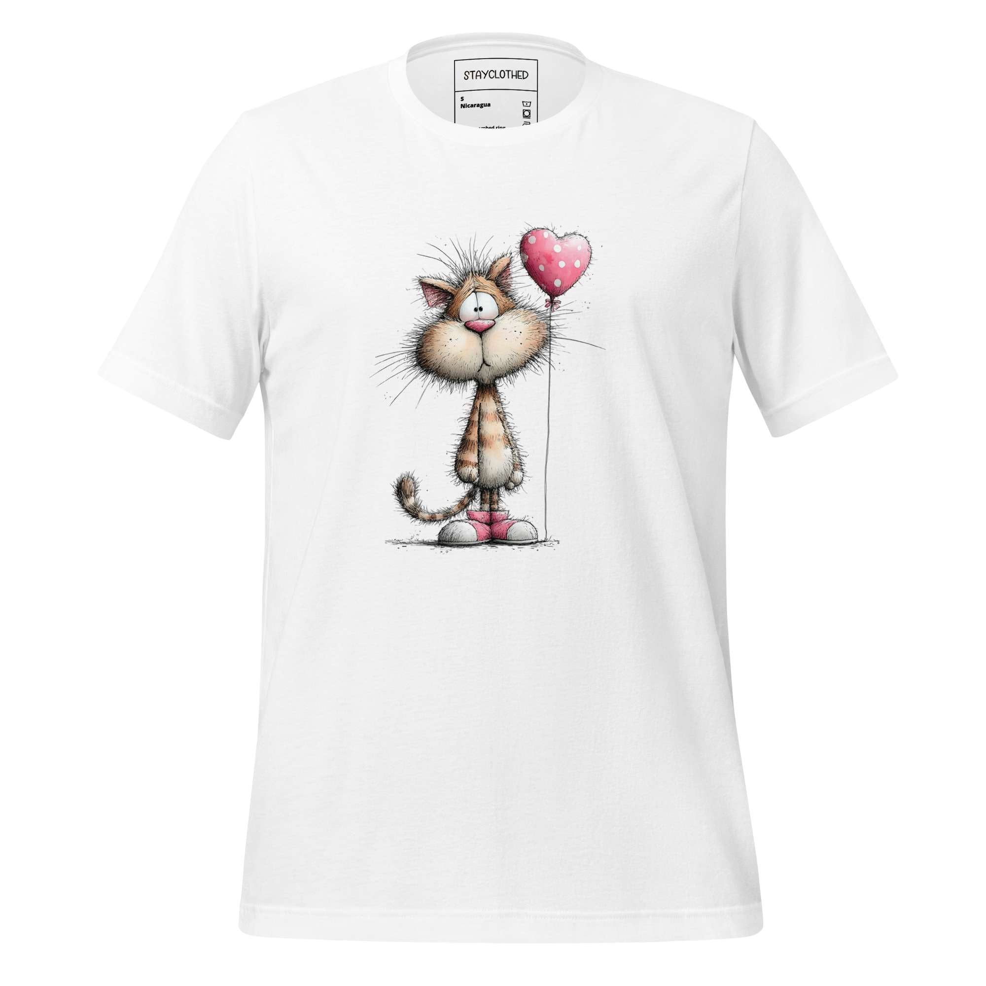 White t-shirt with cartoon cat design on a wooden surface, featuring the brand 'StayClothed'.