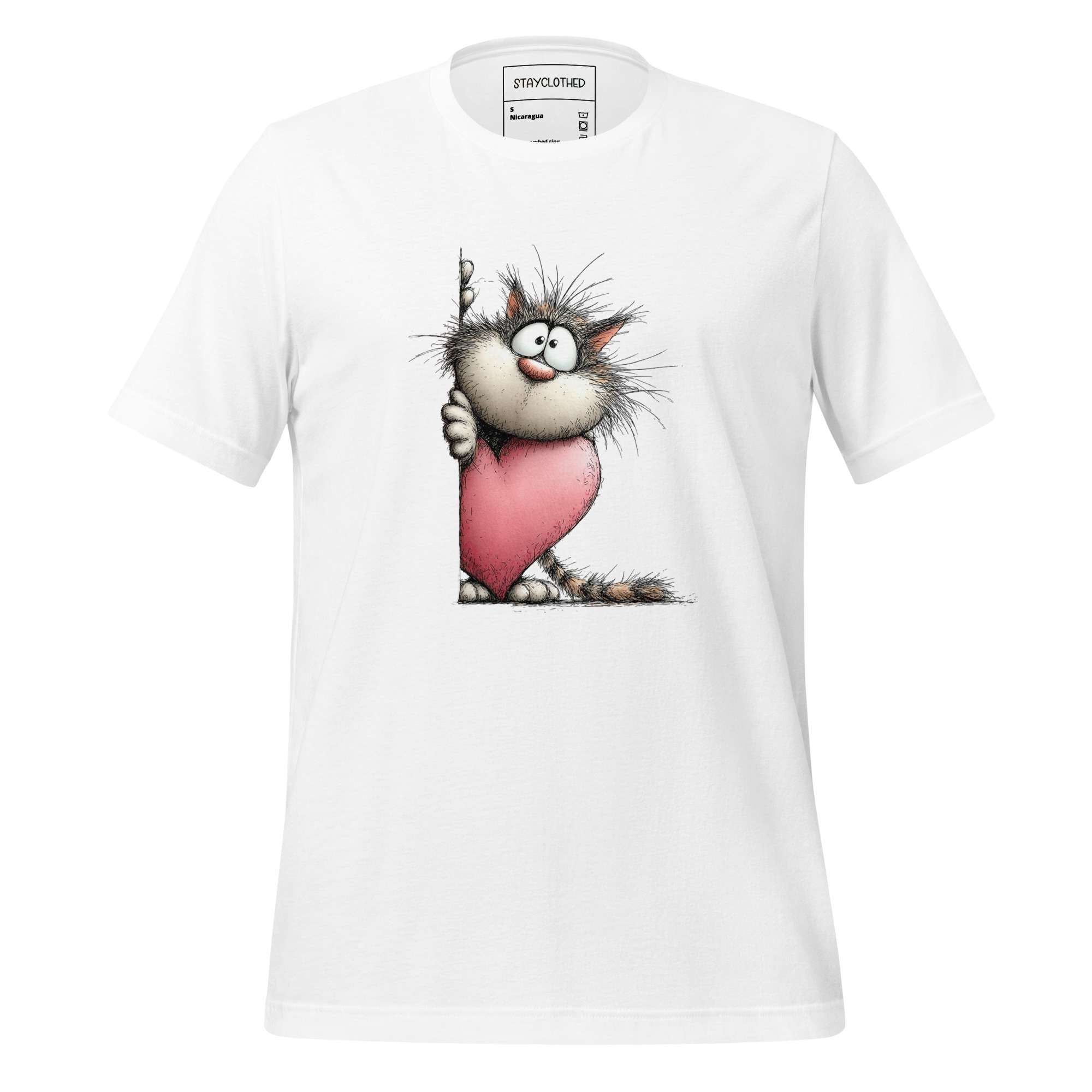 White t-shirt with cartoon cat holding a pink heart on a wooden surface, featuring the brand 'StayClothed'.