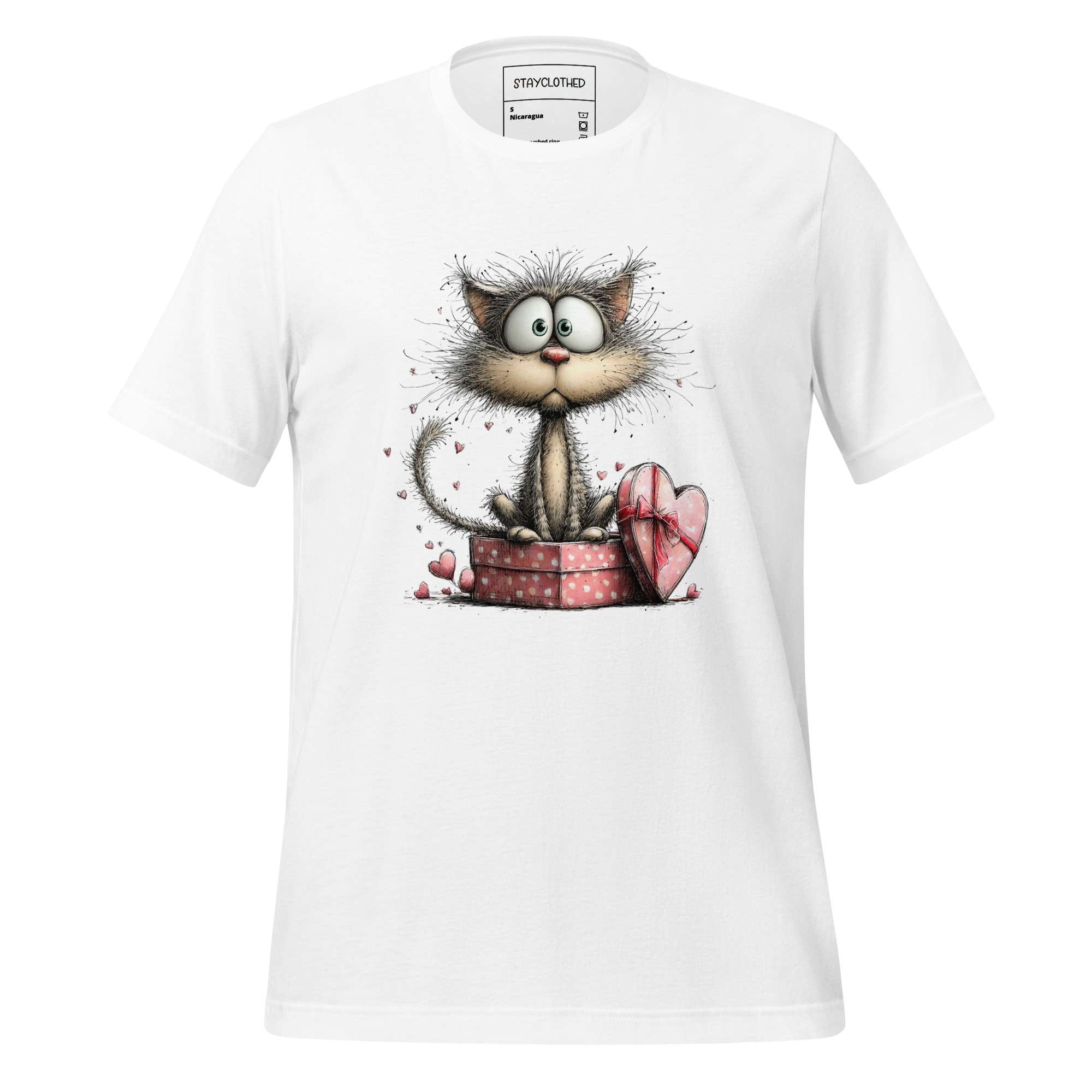 White t-shirt with a cartoon cat design on a wooden surface, featuring the brand 'StayClothed'.