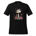 Black t-shirt with a cat and flower design on a wooden surface, featuring the brand 'StayClothed'.