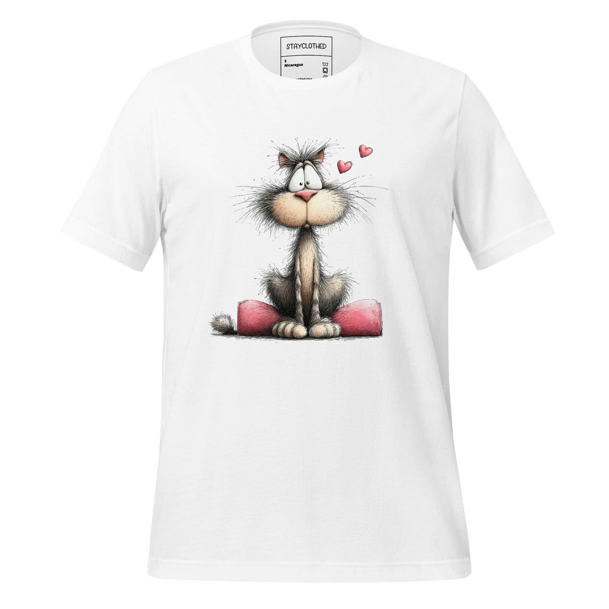 White t-shirt with a cartoon cat design on a wooden surface, featuring the brand 'StayClothed'.