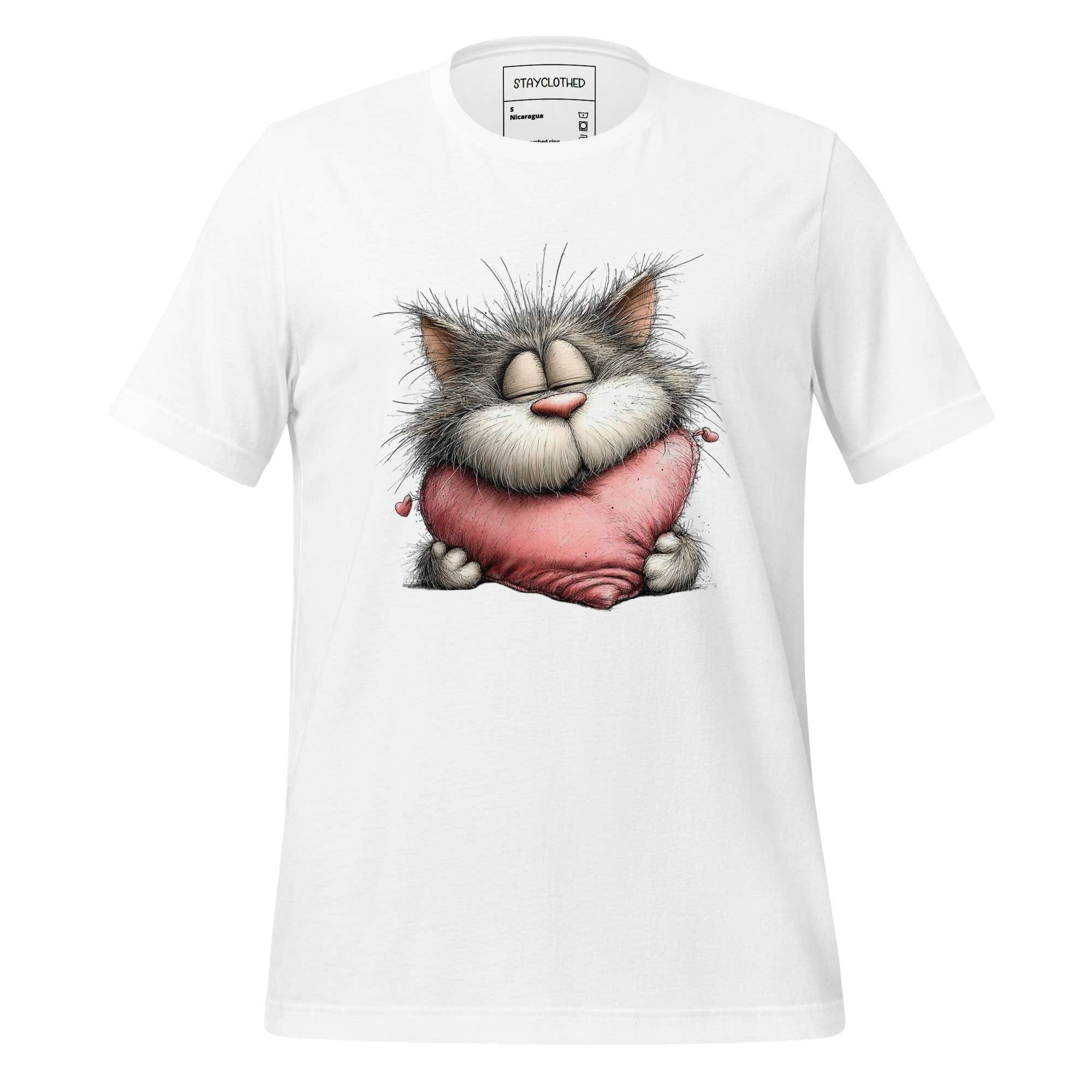 White t-shirt with a cartoon cat design on a wooden surface, featuring the brand 'StayClothed'.