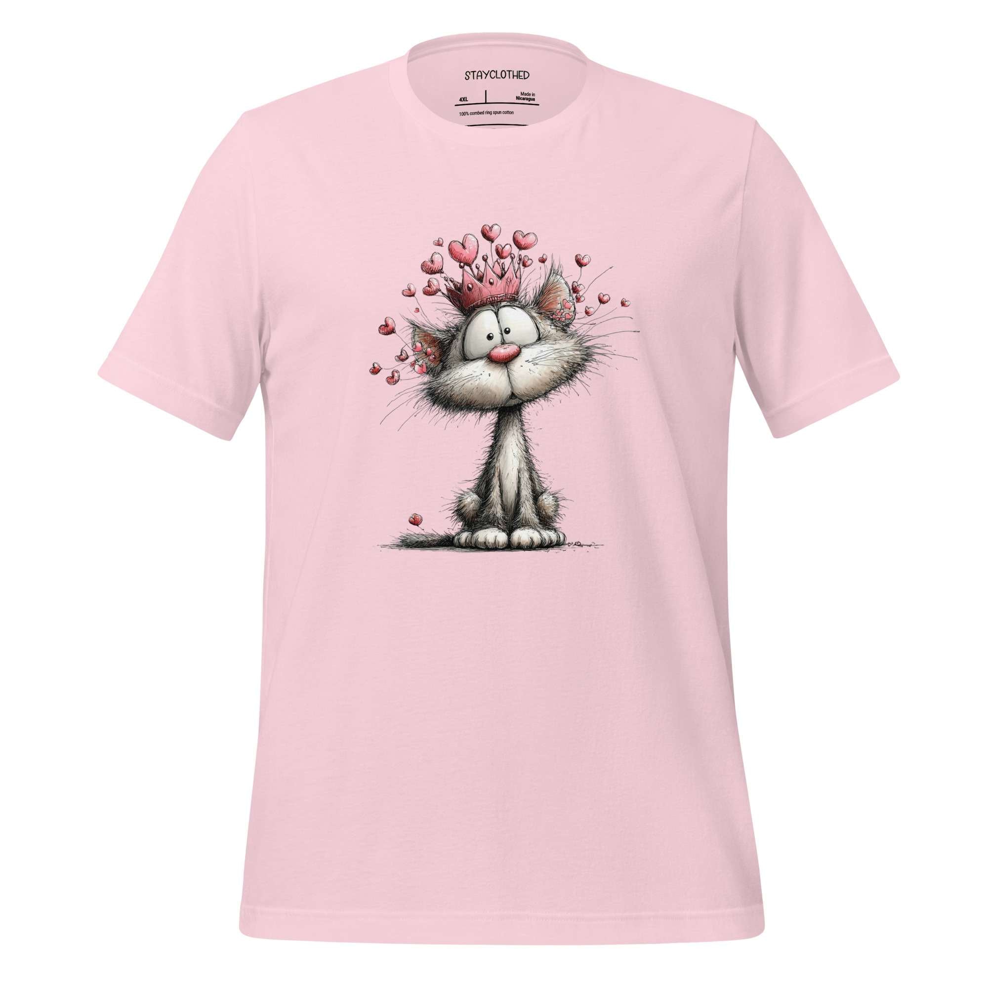 Pink t-shirt with a cartoon cat design on a wooden surface, featuring the brand 'StayClothed'.