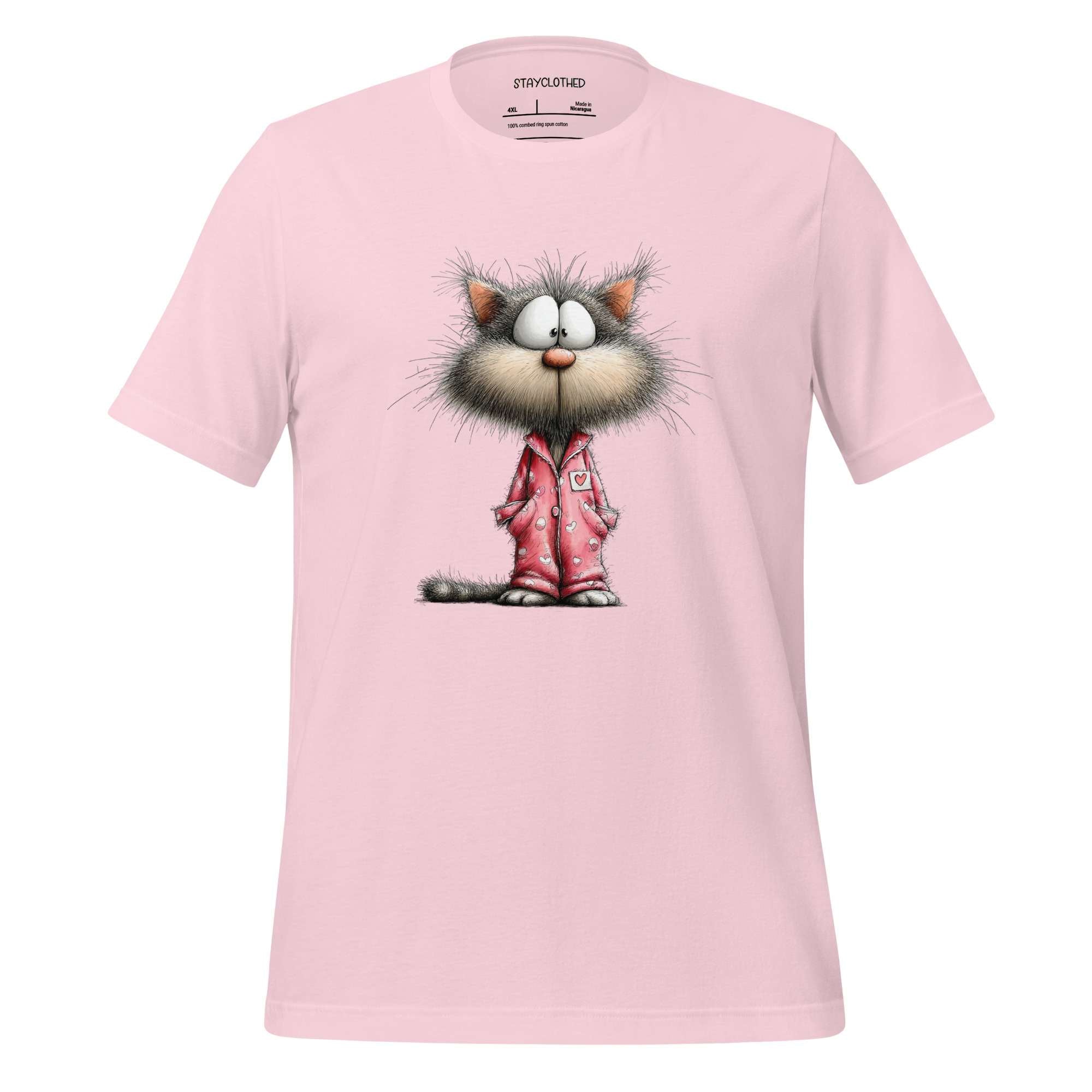 Pink t-shirt with a cartoon cat design on a wooden surface, featuring the brand 'StayClothed'.