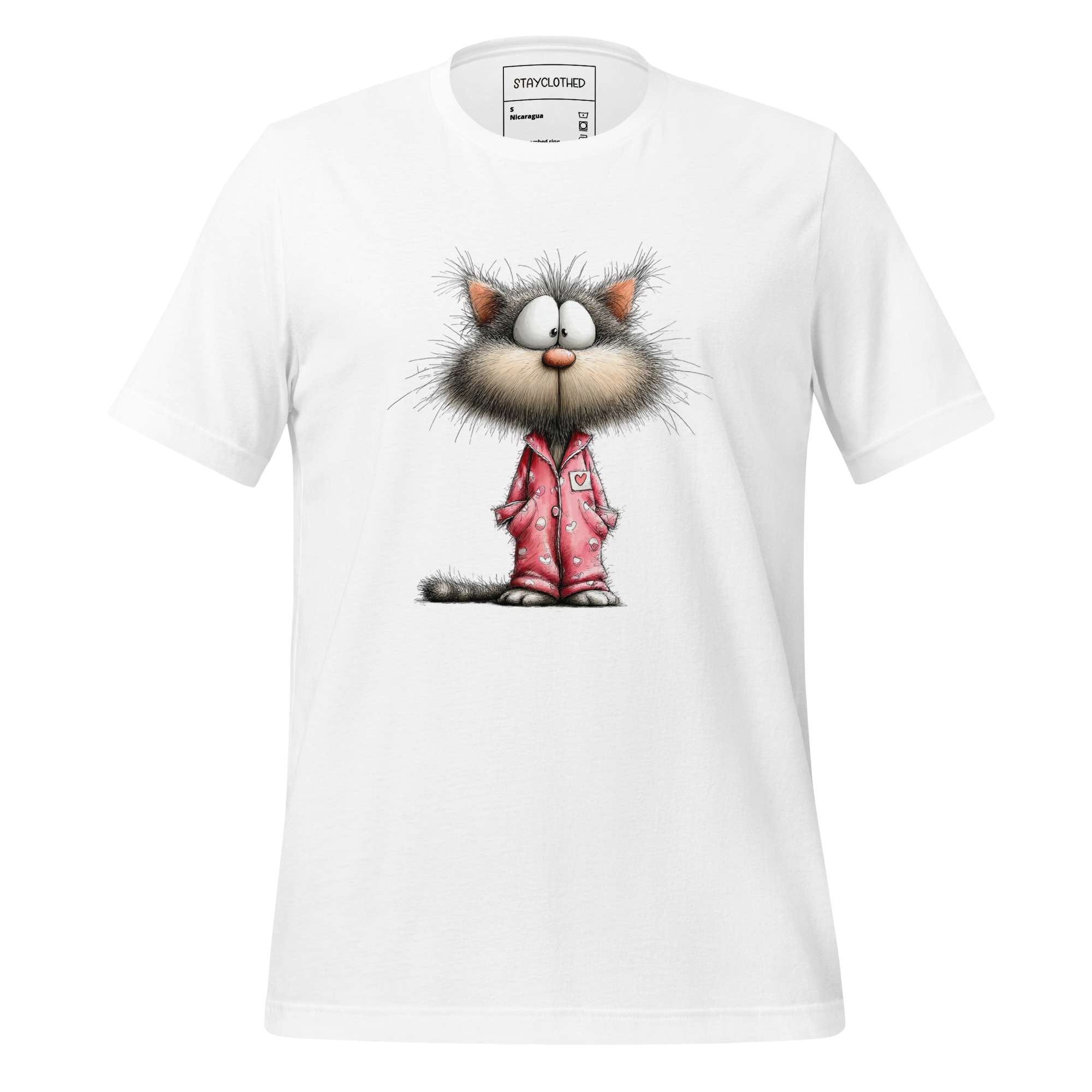 White t-shirt with a cartoon cat design on a wooden surface, featuring the brand 'StayClothed'.