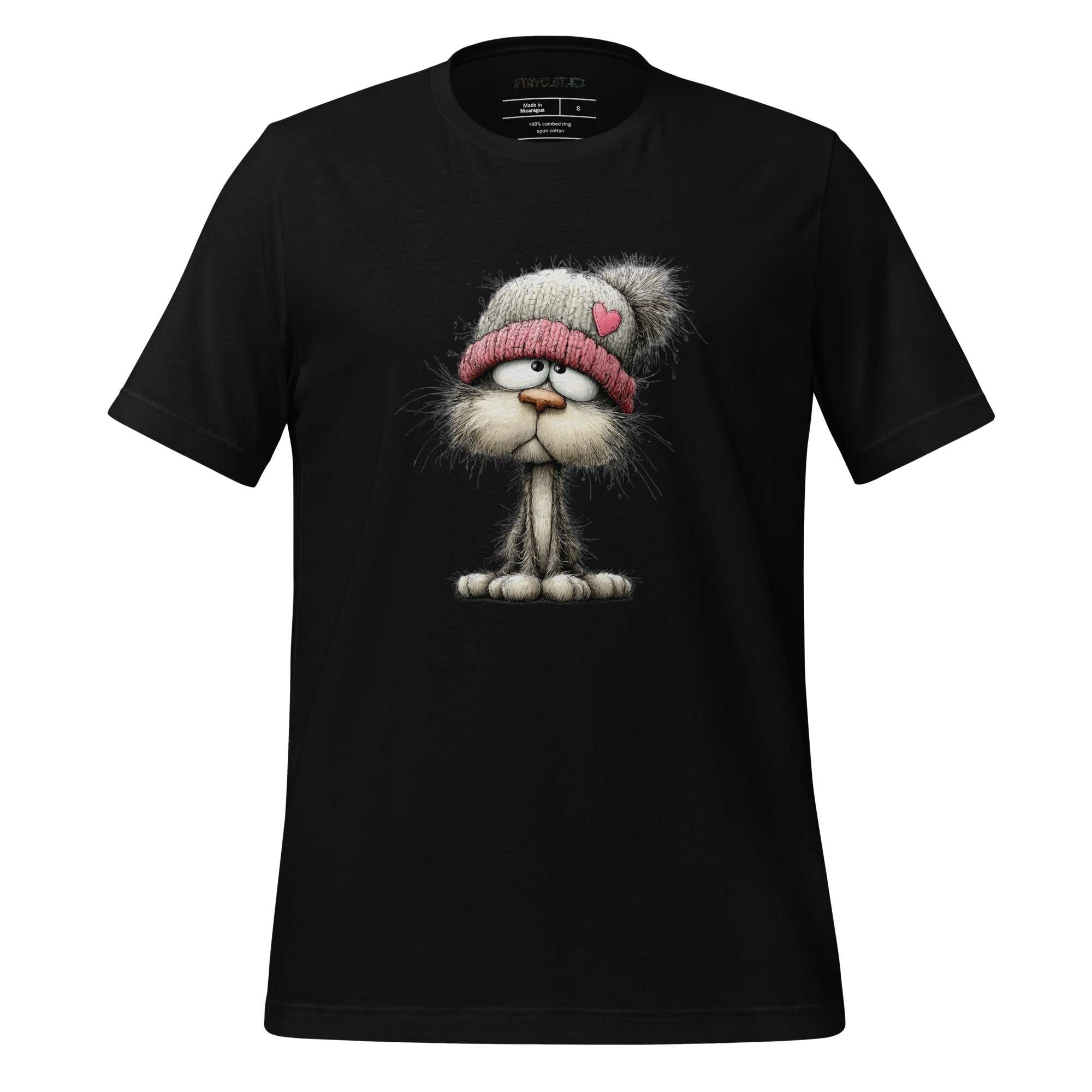 Black t-shirt with a cartoon cat wearing a hat on a wooden surface, featuring the brand 'StayClothed'.