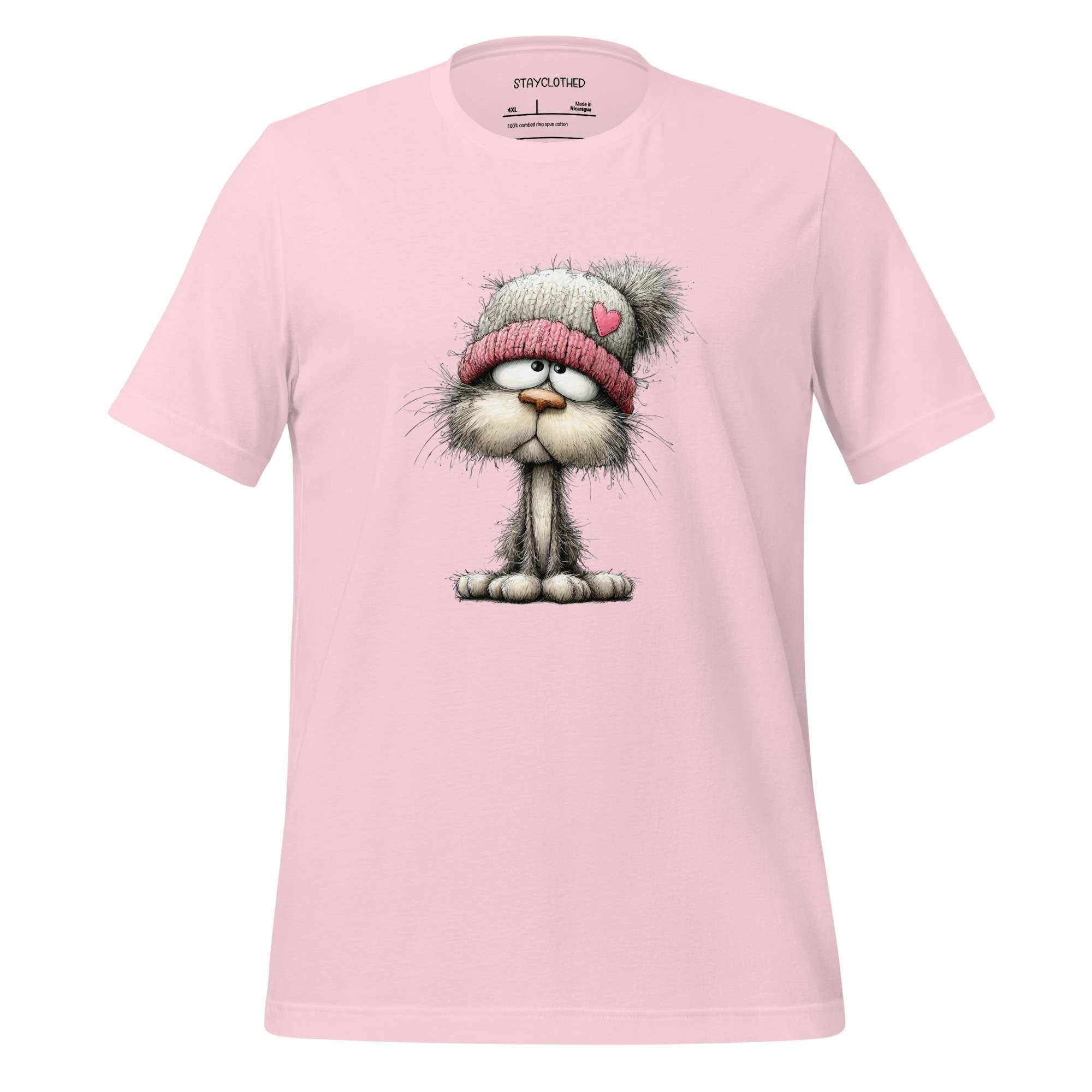 Pink t-shirt with a cartoon cat wearing a pink beanie on a wooden surface, branded 'StayClothed'.