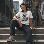 Streetwear model in a funny skeleton t-shirt sitting on concrete steps in an urban setting
