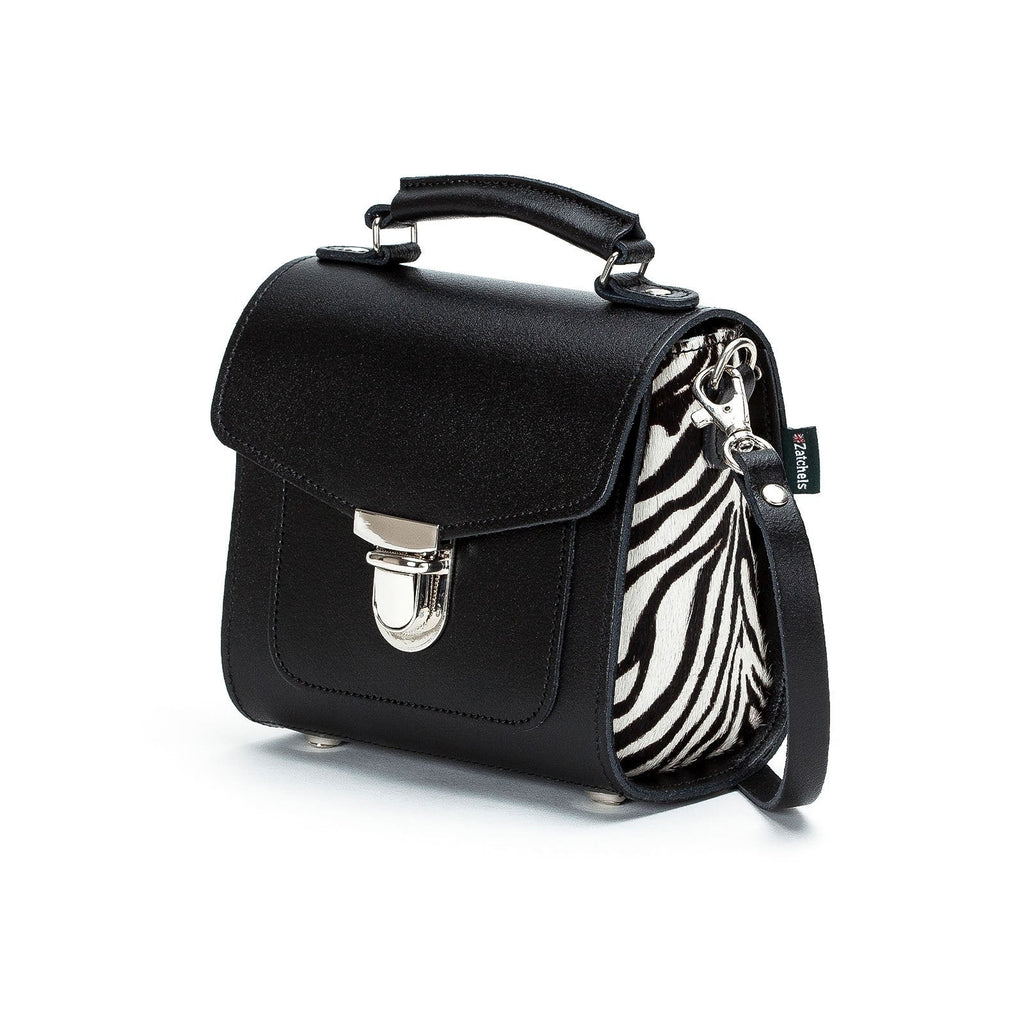 Black handbag with zebra pattern interior on a white background