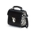 Black handbag with zebra pattern interior on a white background