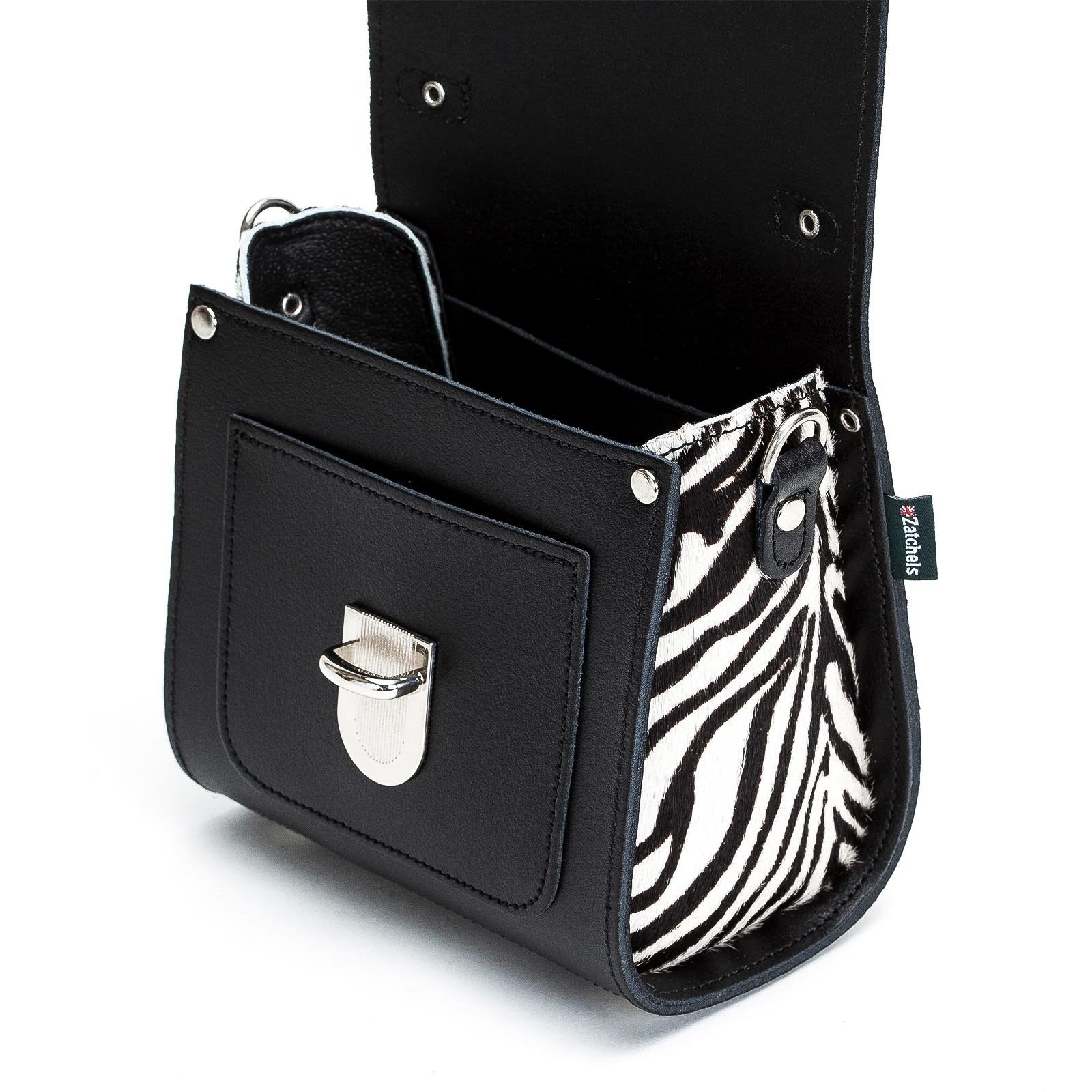 Black handbag with zebra pattern interior pocket on a white background