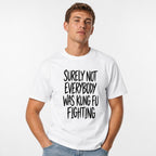 Front view of a white T-shirt with bold black hand-drawn lettering reading “Surely Not Everybody Was Kung Fu Fighting.”