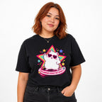 Model wearing a black T-shirt featuring a white cat in heart-shaped sunglasses before a colorful star, with pink text reading “The Horrors Persist But So Do I.”