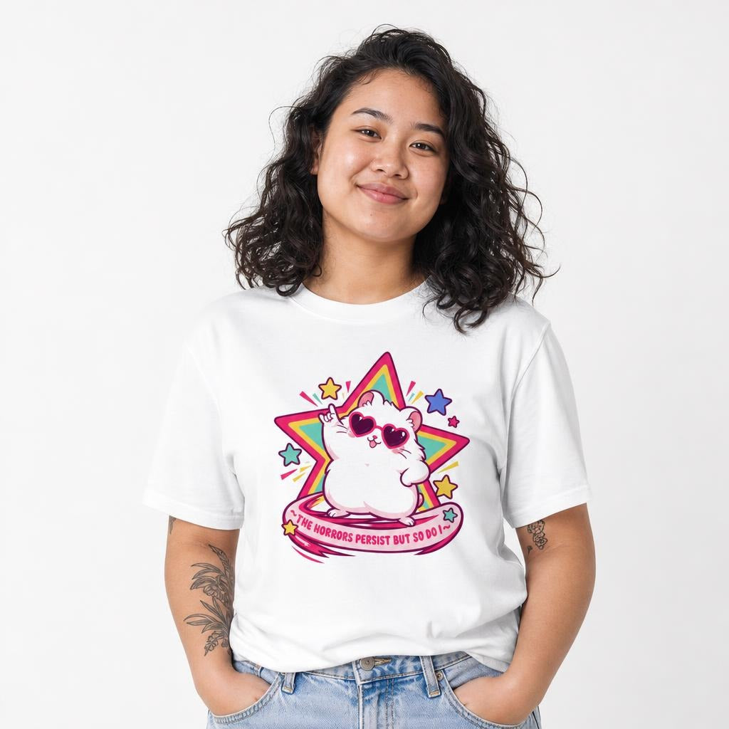 Model wearing a White T-shirt with a kawaii cat in heart-shaped sunglasses before a colorful star and the words “THE HORRORS PERSIST BUT SO DO I.”