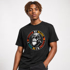 Model wearing a black T-shirt with a circular graphic of a sunglass-wearing monkey in a leather jacket and cap.